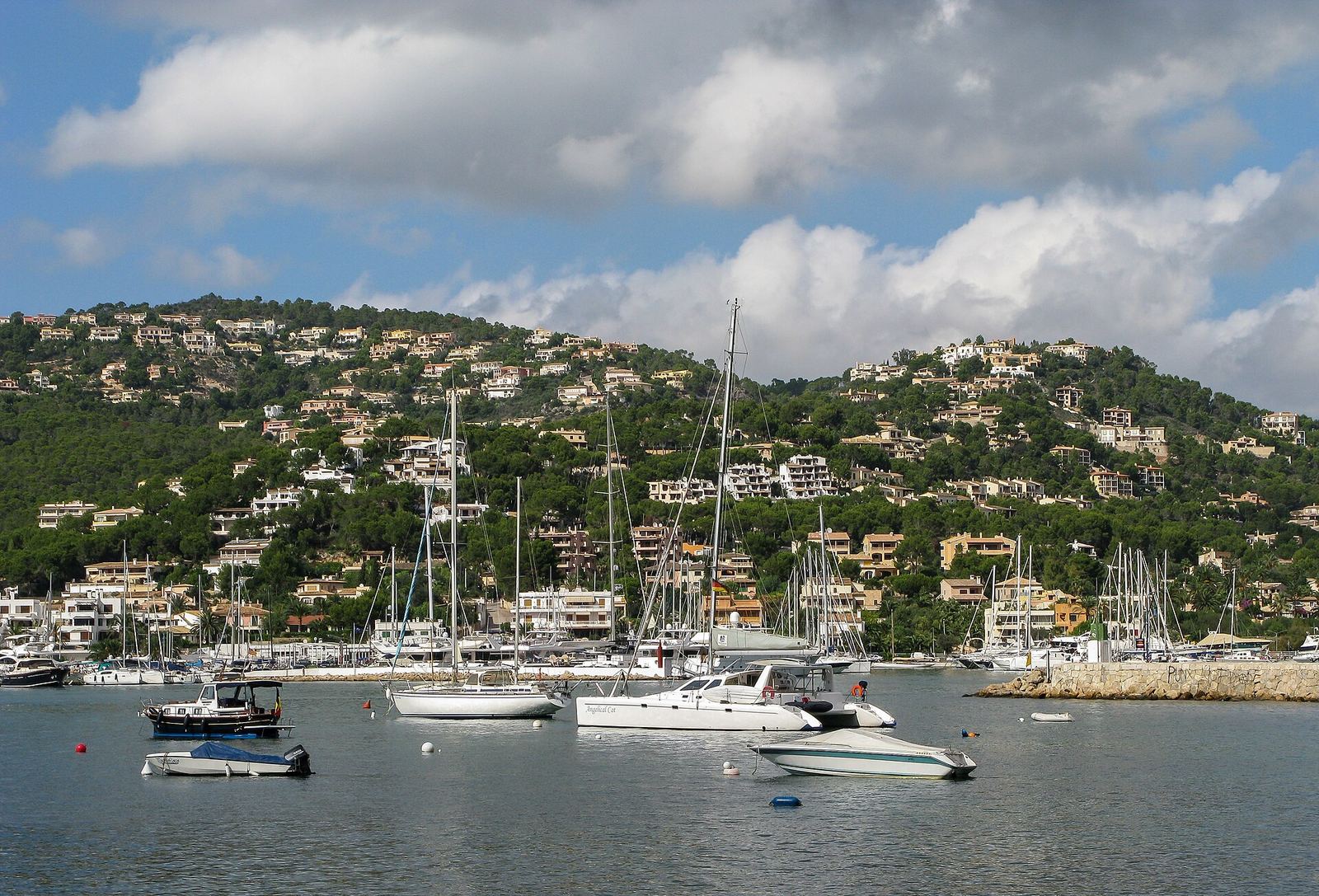 Port d'Andratx harbour with hillside villas, Mallorca — property management by SOLUXE